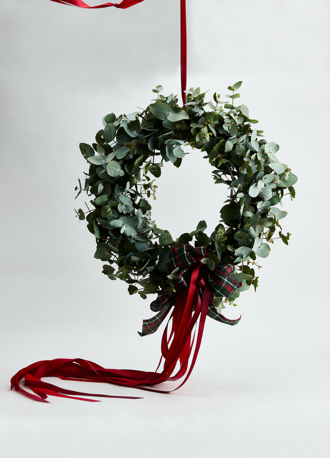 Jolly Wreath Workshop by Flowerdose — festive Christmas wreath made with fresh gum foliage, styled with a tartan bow and cascading red ribbons. A luxury Melbourne floral workshop experience where you’ll create your own handcrafted holiday wreath using seasonal greenery and elegant festive accents — perfect for Christmas home styling or gifting.