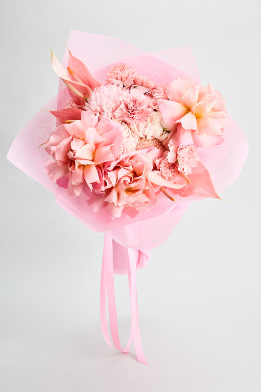 Pink Affair Bouquet of vibrant pink flowers wrapped in pink paper with ribbons created by flowerdose.