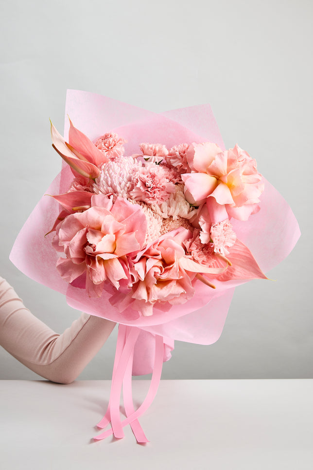 Pink Affair Bouquet of vibrant pink flowers wrapped in pink paper with ribbons created by flowerdose.