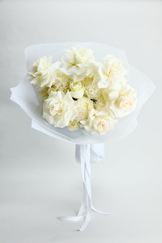 Pure grace white bouquet flowers held by flowerdose